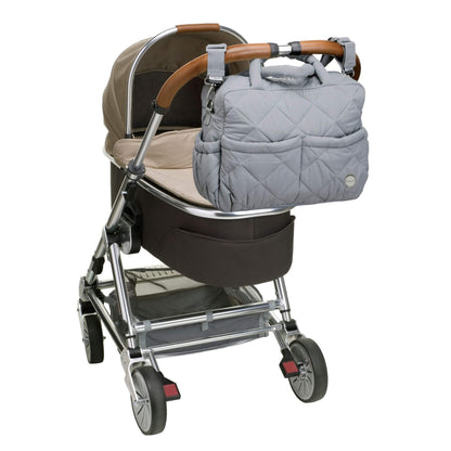 Soft quilted Babymel Willow Convertible Changing Bag in duck egg grey, securely attached to a pram with built-in stroller straps for hands-free convenience.