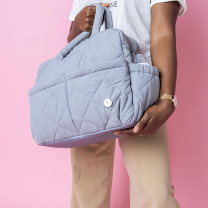 Close-up of the Babymel Willow Convertible Changing Bag in duck egg grey, highlighting its quilted design, side bottle pocket, and stylish details.