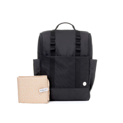 Babymel Finn Changing Backpack in Black, displayed with a folded leopard-print changing mat.