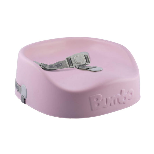 Bumbo booster seat in cradle pink, lightweight foam seat with safety harness, ideal for secure child seating at the table."