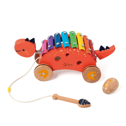 Classic World Dinosaur Xylophone toy with vibrant keys, pull-along wheels, wooden mallet, and maraca, ideal for musical fun and play.