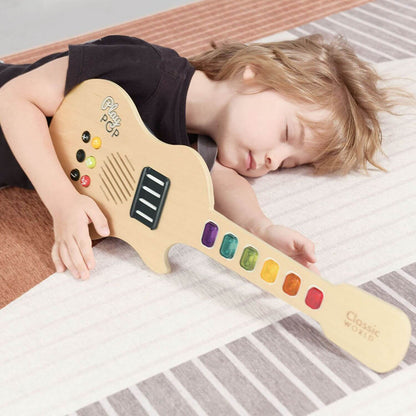 Child resting with the Classic World Electric Glowing Wooden Guitar, featuring rainbow-coloured keys and sound effect buttons for creative play.