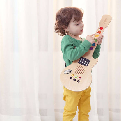 Child playing with the Classic World Electric Glowing Wooden Guitar, exploring colourful keys and sound effects for musical creativity.