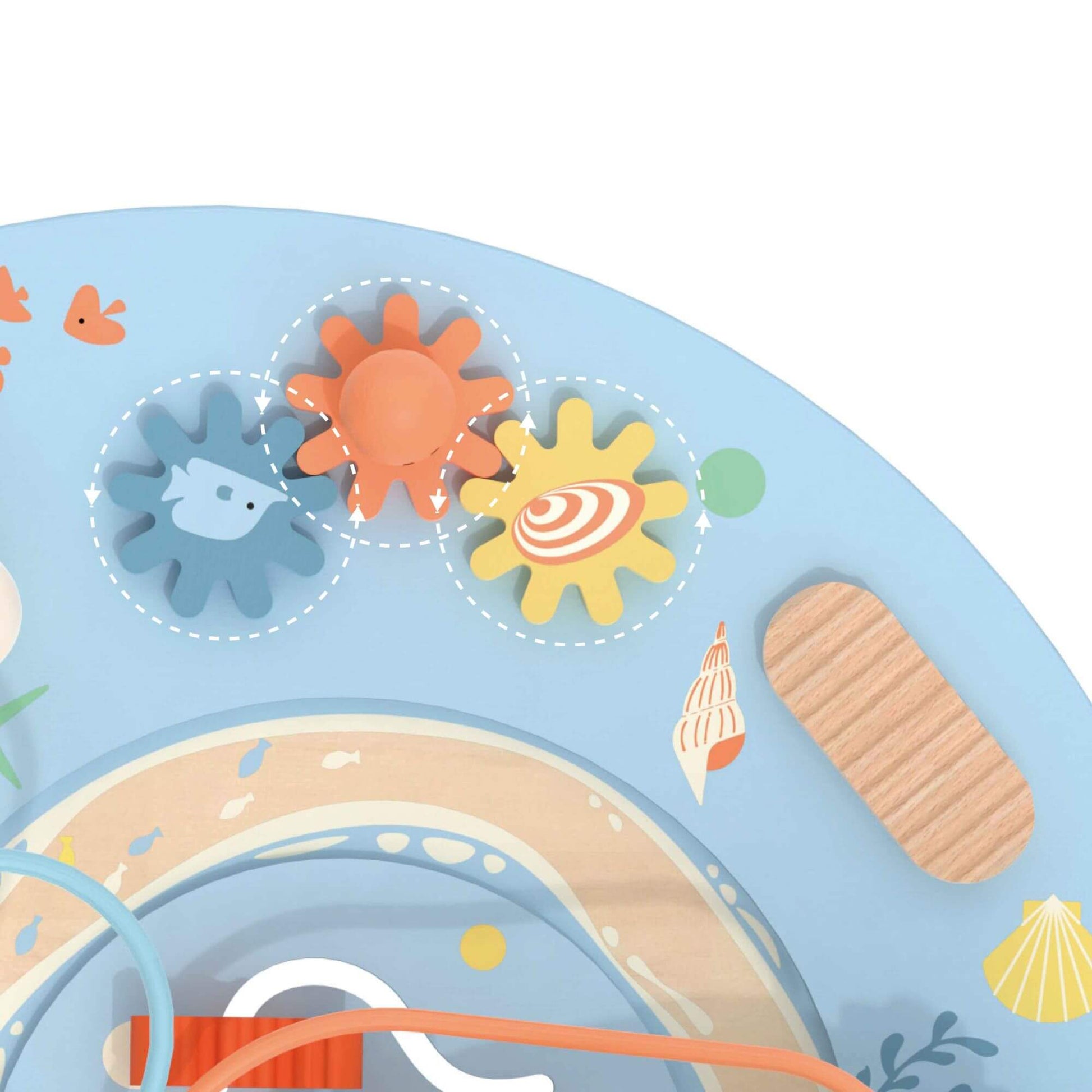 Close-up of the Classic World Multi-Activity Table’s colourful spinning gears with ocean-themed designs, featuring a fish and seashells.