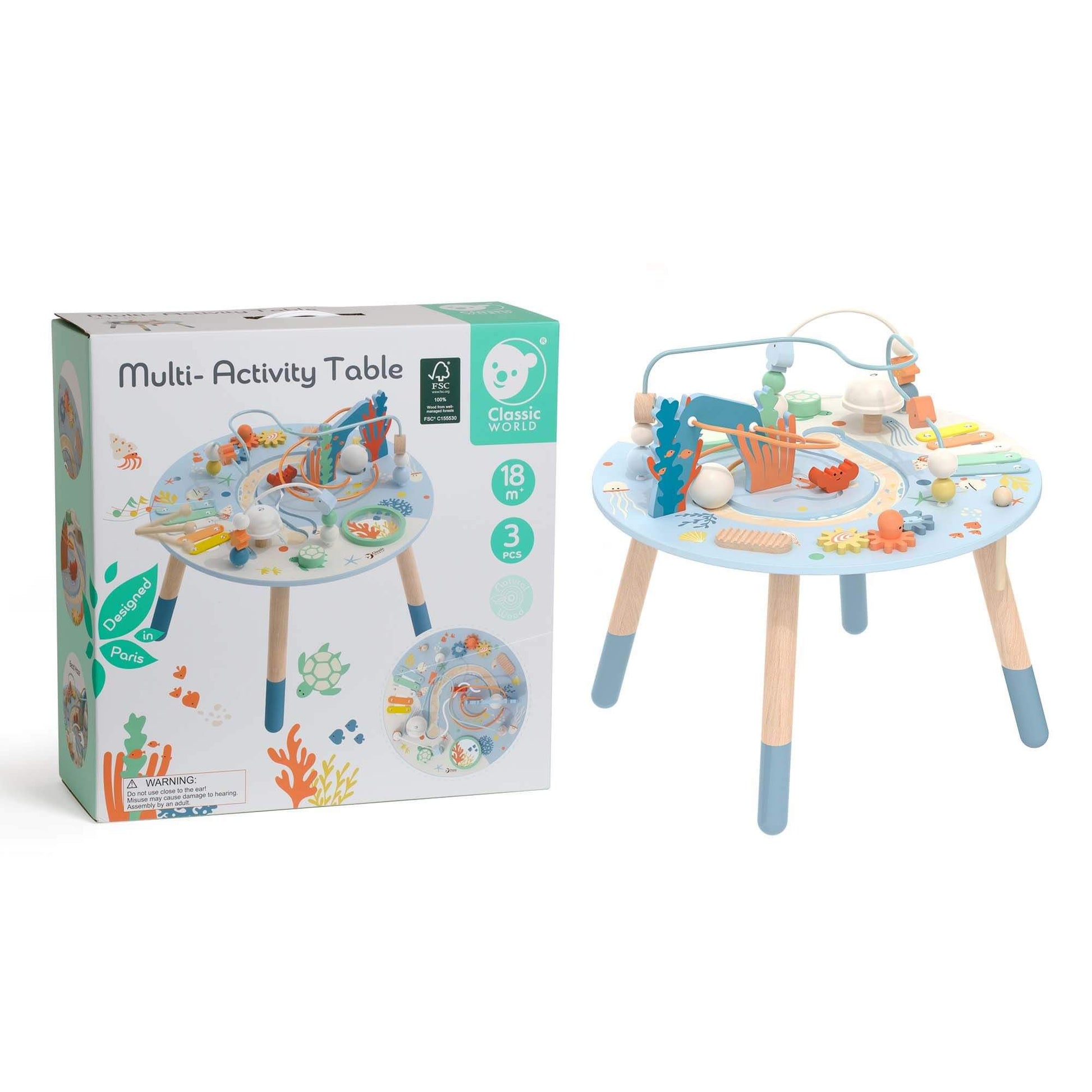 Classic World Multi-Activity Table with ocean-themed design shown alongside its packaging, featuring interactive elements and FSC-certified wood.