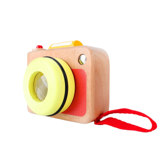 Wooden Classic World My First Camera with a yellow kaleidoscope lens, red shutter button, and a red strap for easy carrying.