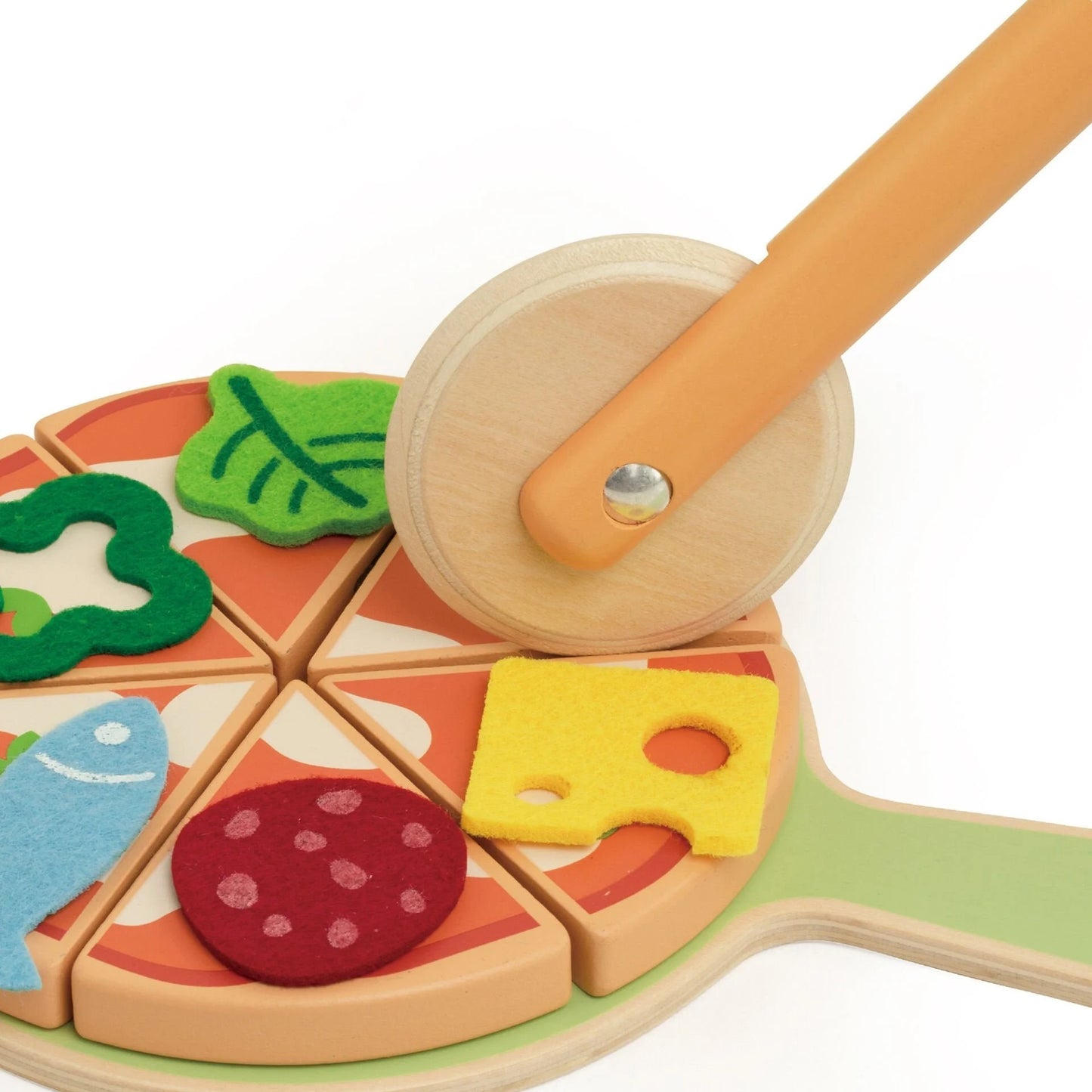 Close-up of the Classic World Pizza Oven set showing a wooden pizza cutter slicing through pizza pieces topped with colourful felt toppings.