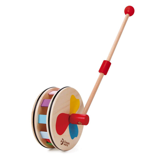 A colourful wooden push-along toy by Classic World, featuring a spinning drum with rainbow-coloured blocks and an easy-to-grip handle.