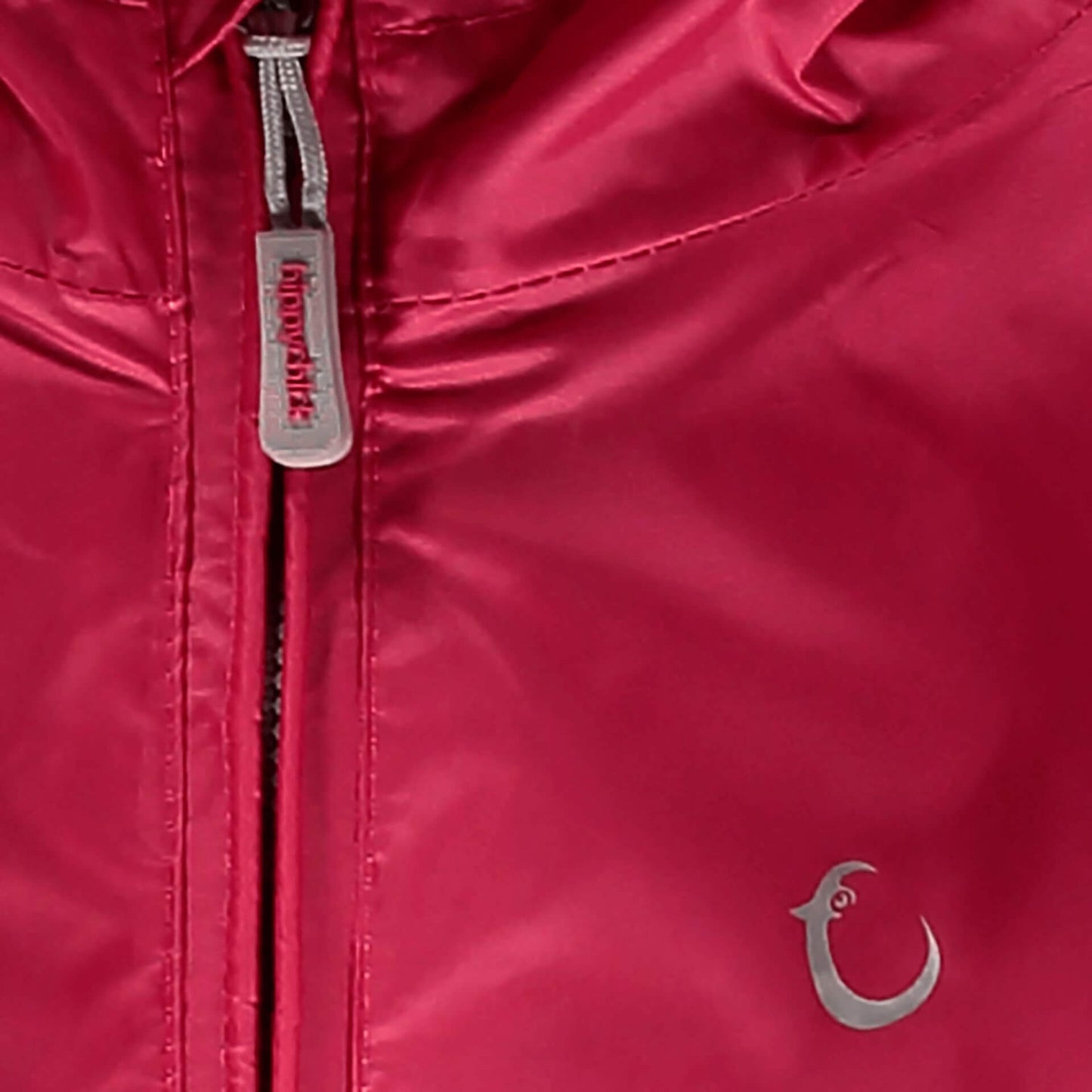 Close-up of a pink Packasuit zipper with a small, silver Hippychick logo near the bottom right corner.