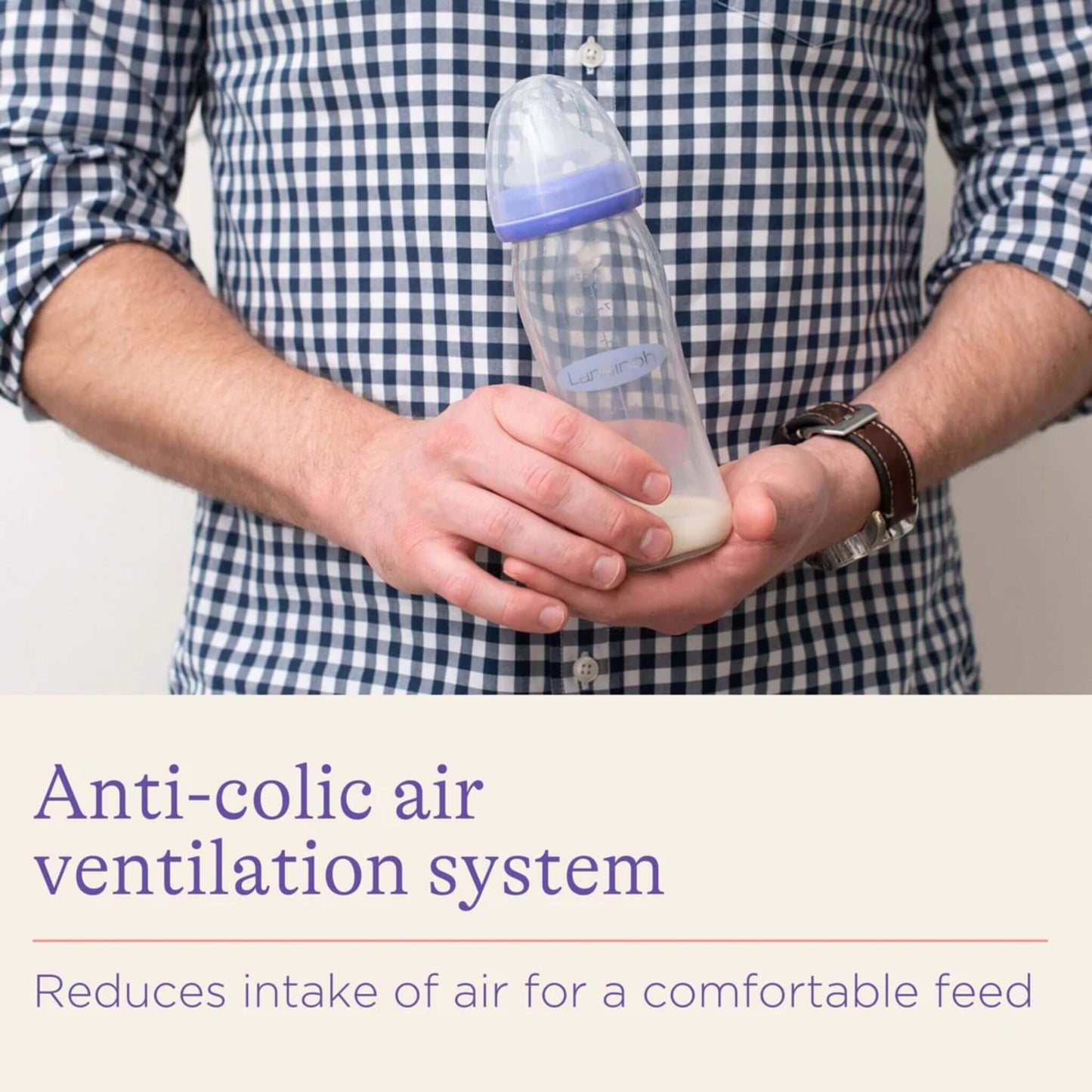 Person holding a Lansinoh bottle, highlighting the anti-colic air ventilation system designed to reduce air intake for a more comfortable feeding experience.