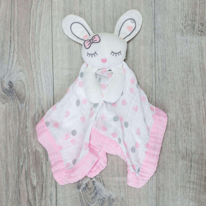 Lulujo Pink Bunny Lovey displayed on wooden background showcasing the sleeping bunny face design, pink trim and soft muslin fabric.