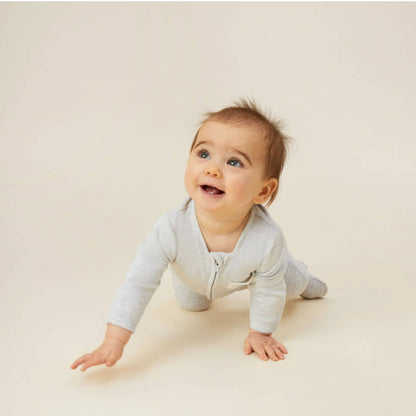 Baby crawling while wearing the MORI Clever Zip Sleepsuit in grey, featuring a two-way front zip and a small chest pocket, designed for comfort and easy movement.