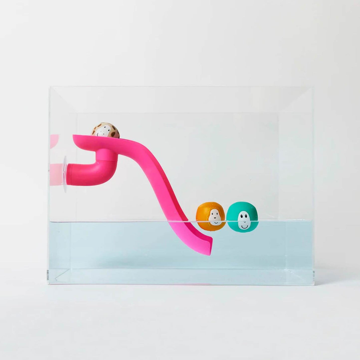 Pink Matchstick Monkey slide set attached to the side of a transparent bath with three floating animal rocks, ideal for water play