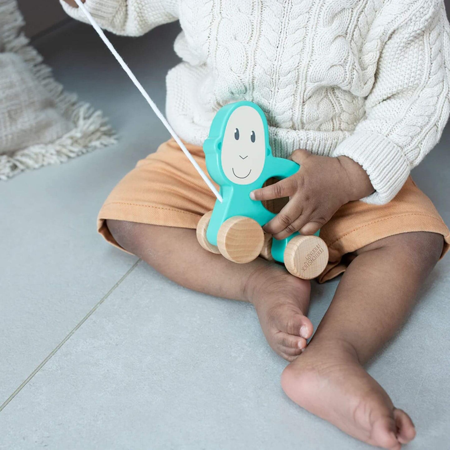 Matchstick Monkey wooden pull-along toy, designed for toddlers to enhance fine motor skills, easy to grip and perfect for engaging imaginative play.