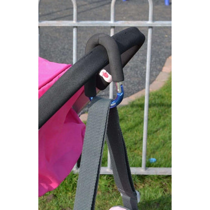 buggy clip securing a strap to a stroller, offering hands-free convenience for carrying bags and essentials on the go.