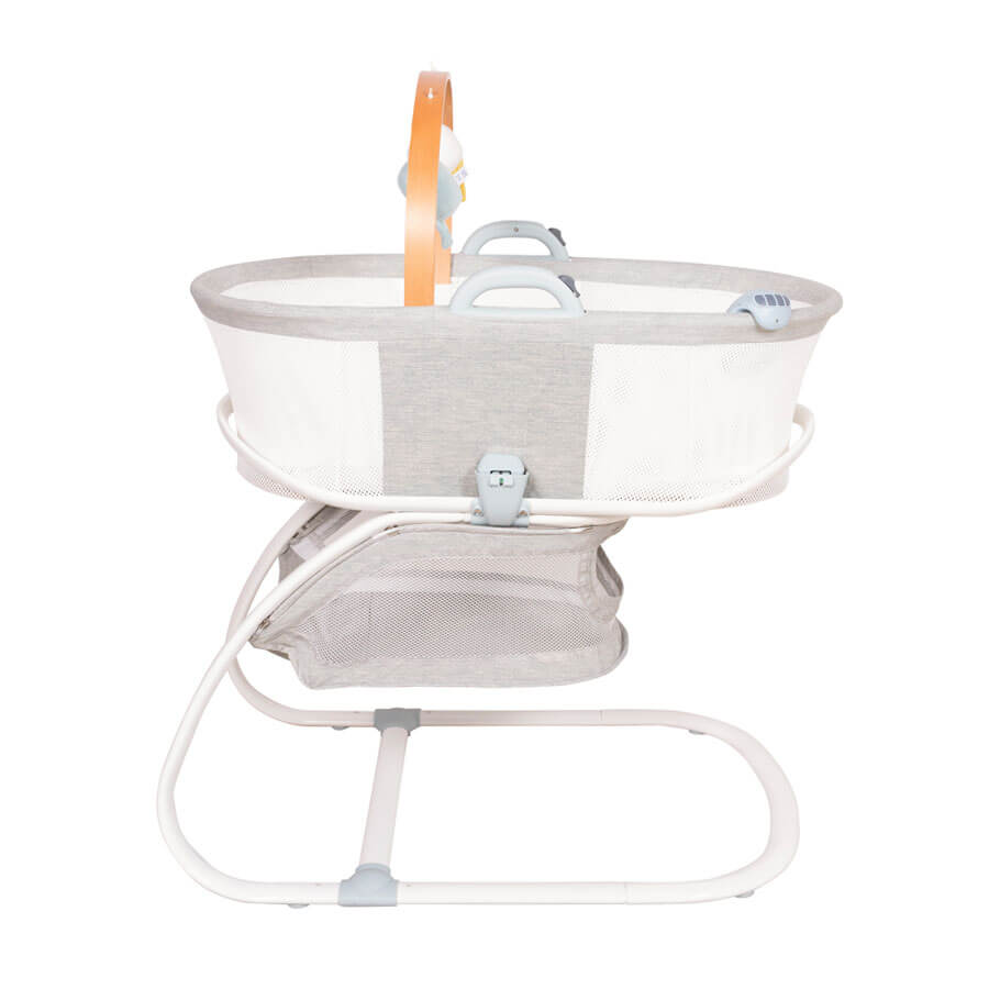 Side view of Purflo breathable crib, showcasing mesh panels for airflow, sturdy white frame, modern grey fabric, and convenient storage basket.