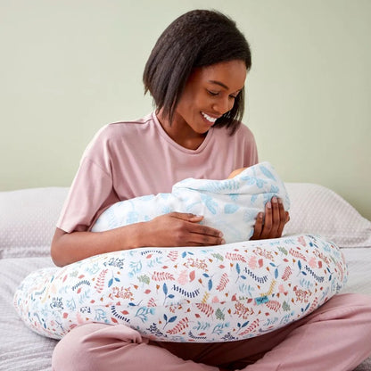 Mother using the Purflo Breathe Pregnancy Pillow in Botanical print for breastfeeding, providing support and comfort for mum and baby.