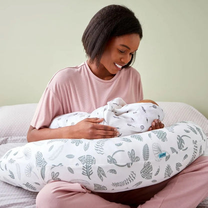 Mother using the Purflo Breathe Pregnancy Pillow in Jardin print for breastfeeding, providing support and comfort for mum and baby.