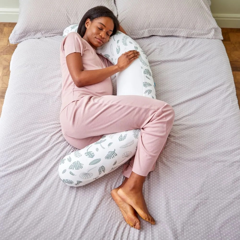 Pregnant woman sleeping with the Purflo Breathe Pregnancy Pillow in Jardin print, offering full-body support and comfort for side sleeping.