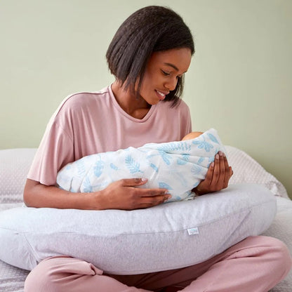 Mother using the Purflo Breathe Pregnancy Pillow in minimal grey for breastfeeding, providing ergonomic support and comfort for mum and baby.