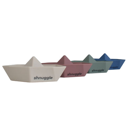 Four Shnuggle Stack ‘n’ Sail Bath Boat Toys in pastel colours lined up, made from BPA-free silicone, perfect for bath-time play.