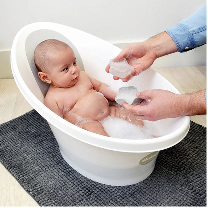 Baby in a Shnuggle bath enjoying playtime with the Shnuggle Wishy Bath Toy, held by a parent, adding fun to bath time.