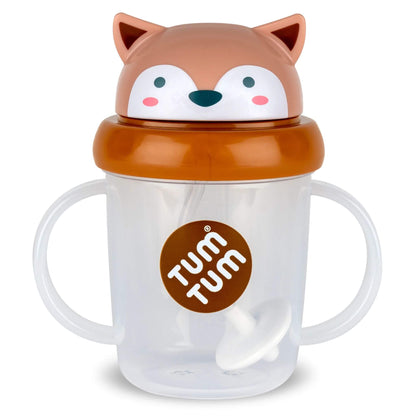 A clear TUM TUM Tippy Up Cup, featuring Fergus Fox lid with handles on both sides for easy gripping. The cup includes a weighted straw that follows the liquid, allowing toddlers to drink comfortably from any angle.