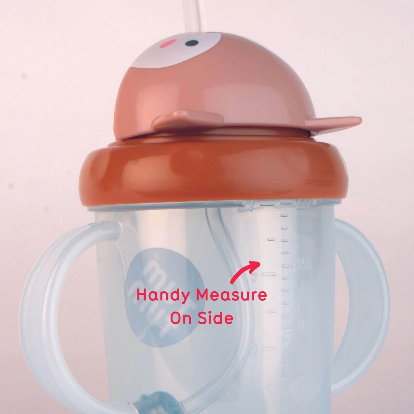 A close-up of the TUM TUM Tippy Up Cup, featuring a Fergus Fox lid and dual handles. The cup shows a handy measurement scale on the side for easy tracking of fluid intake. The weighted straw inside follows the liquid for smooth, any-angle drinking.