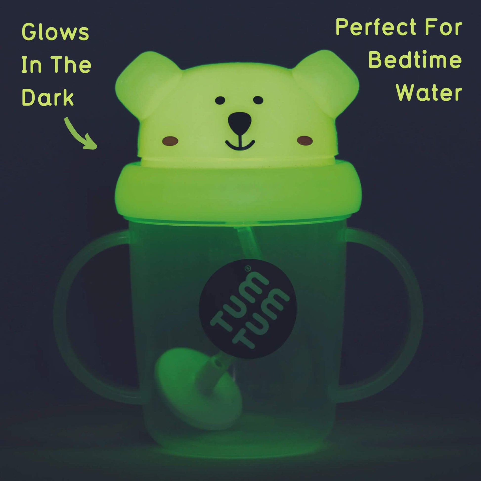 A glow-in-the-dark TUM TUM sippy cup with a polar bear lid, designed for bedtime water. It features a weighted straw that follows the liquid and has easy-grip handles, perfect for use in the dark.