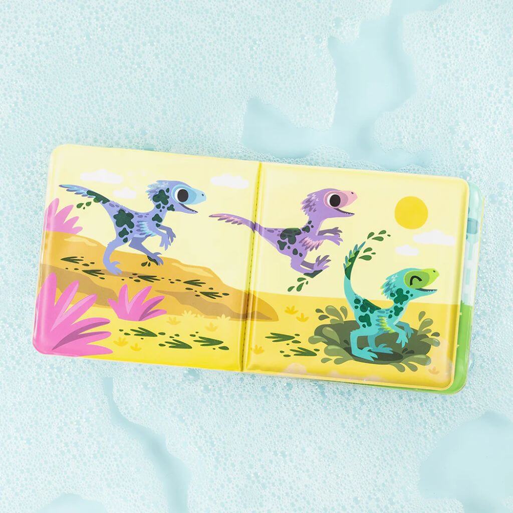 
Tiger Tribe Messy Dinosaurs Bath Book open on a bubbly surface, featuring playful dinosaurs with interactive spots that change in warm and cold water.