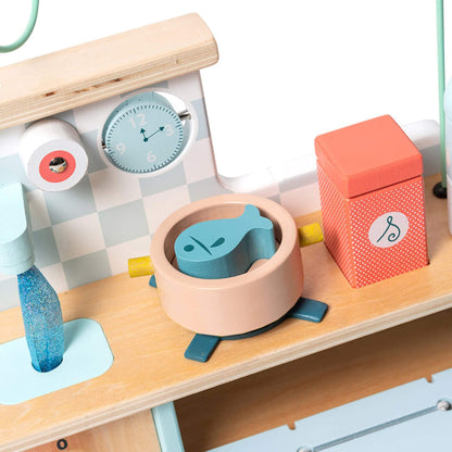 Close-up of Vilac Multi Activity Kitchen featuring clock face, fish pot, salt container and detailed wooden accessories.