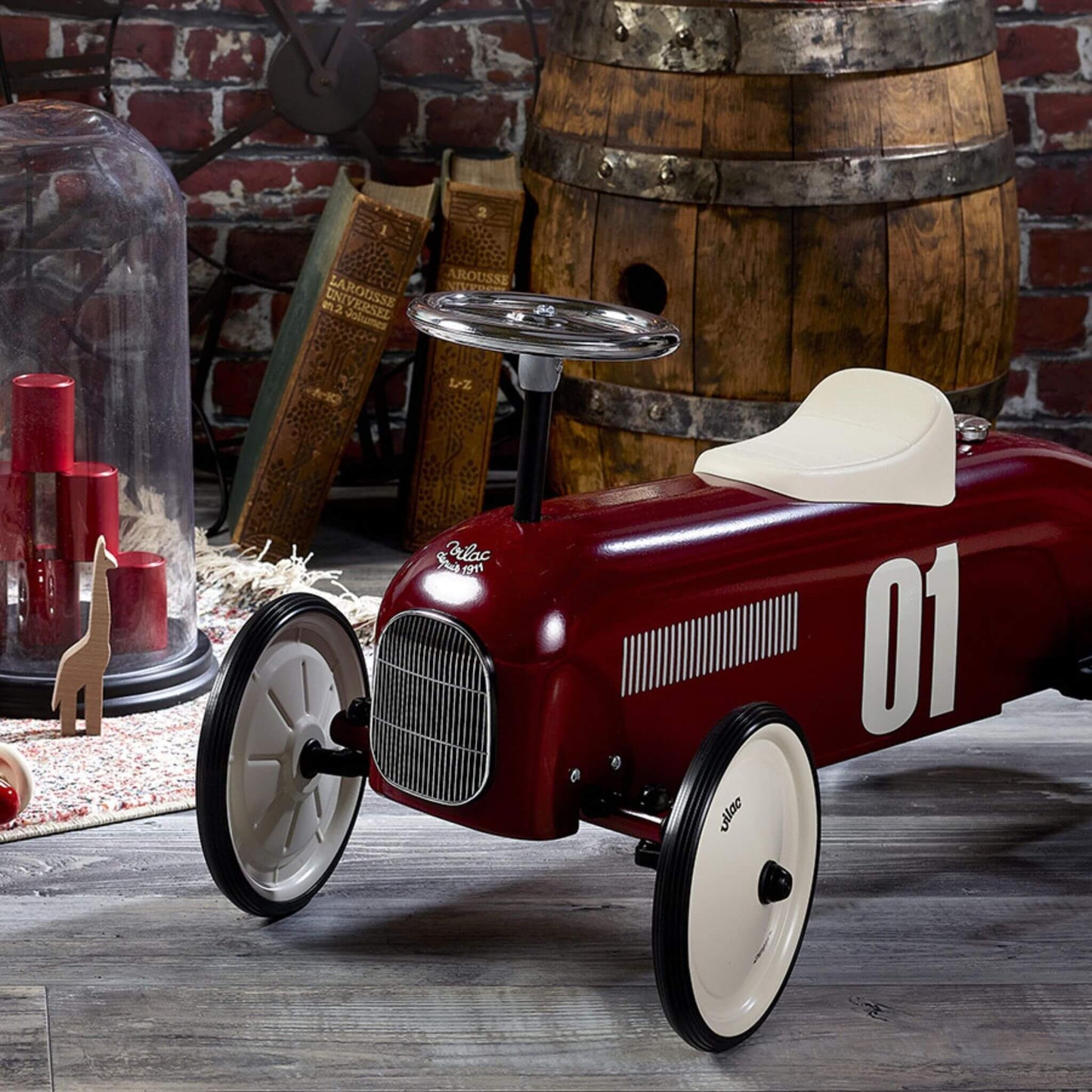 Vilac Classic Metal Car in burgundy with white seat and silver steering wheel, featuring number 01 detail, set in a vintage-themed décor.