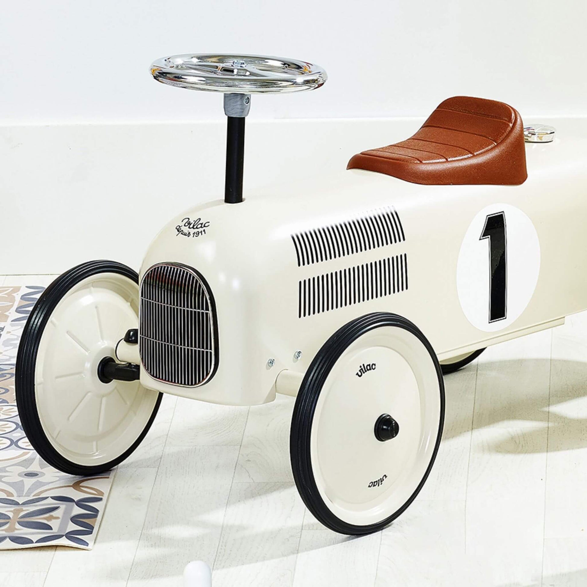 Vilac Classic Metal Car in off-white with a brown seat, silver steering wheel, and number 1 detail, perfect for stylish little racers.