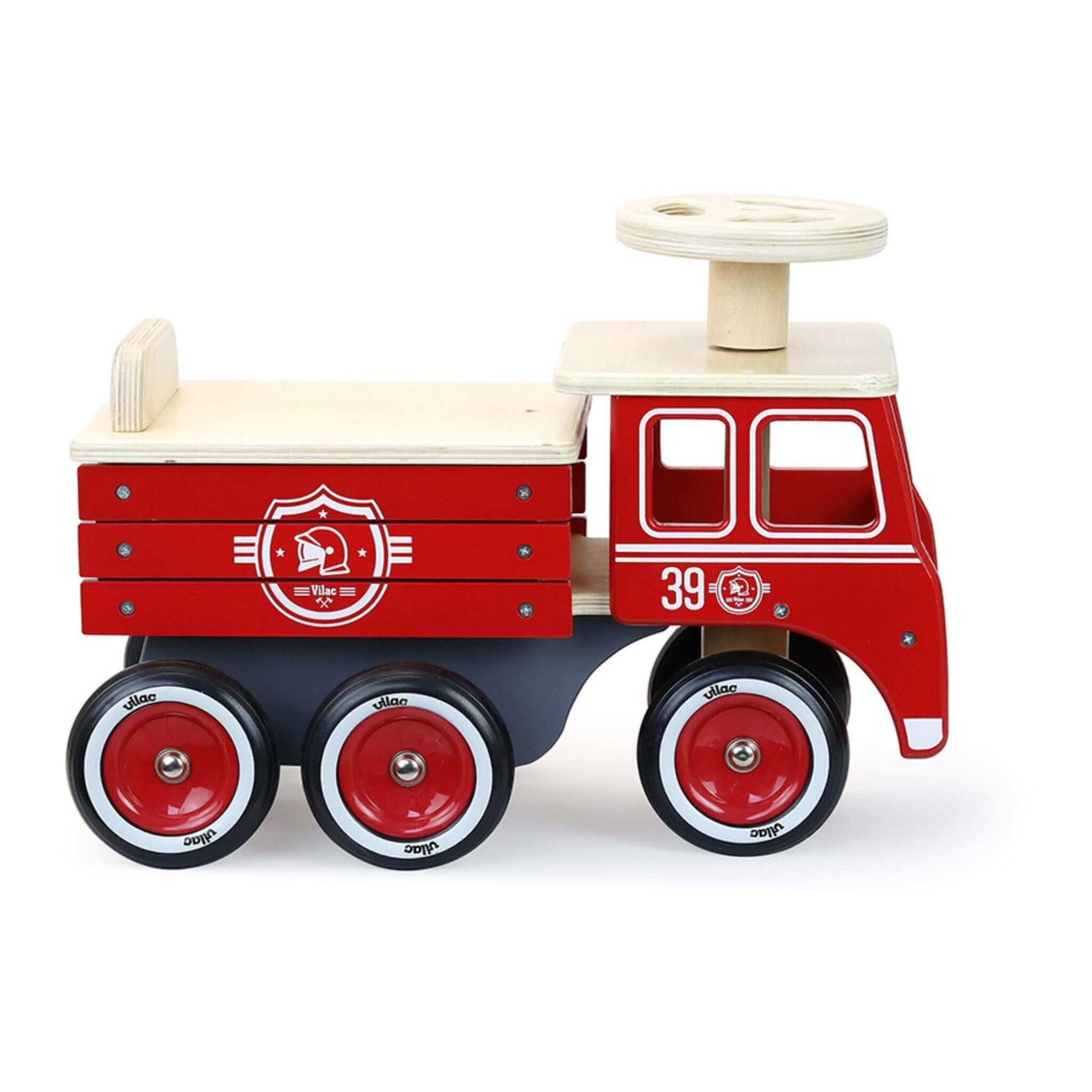 Vintage-design Vilac Ride-On Fire Truck in red, featuring rubber tyres, a sturdy wooden frame, and a seat with built-in storage for toys.